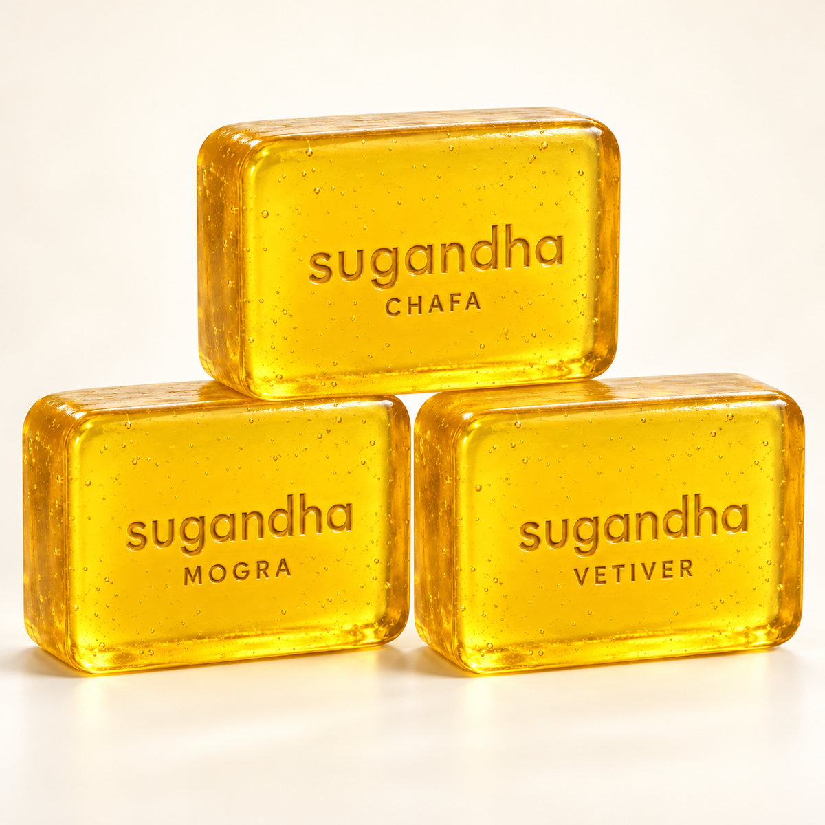 Sugandha Soaps — Pick Any 3: example selection of Chafa, Mogra and Vetiver, three 50 g translucent yellow bars